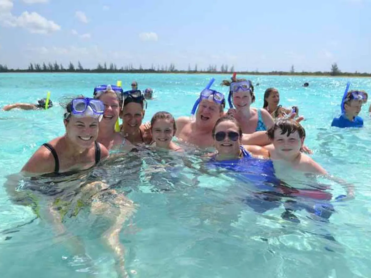 Guests enjoying the crystal-clear sandbar